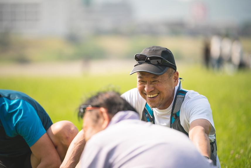 Smiling, mature man playing football