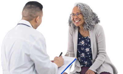 A women happy and listening to her doctor who is reviewing his clipboard.