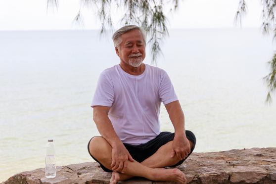 Man meditating outside.