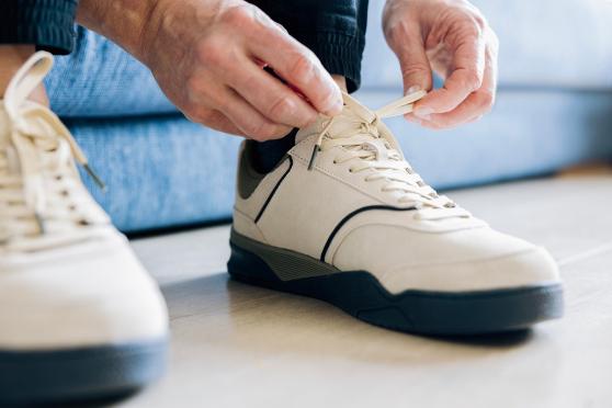 Man tying shoes.
