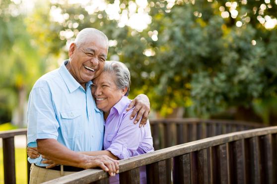 Eldery couple hugging on a bridge